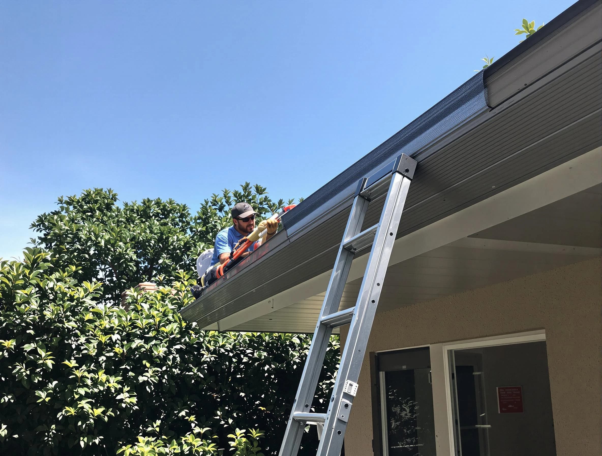 Painesville Roofing Company installing gutter guards for a homeowner in Painesville, OH